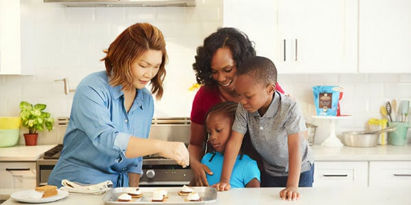 Multiracial family in kitchen cooking