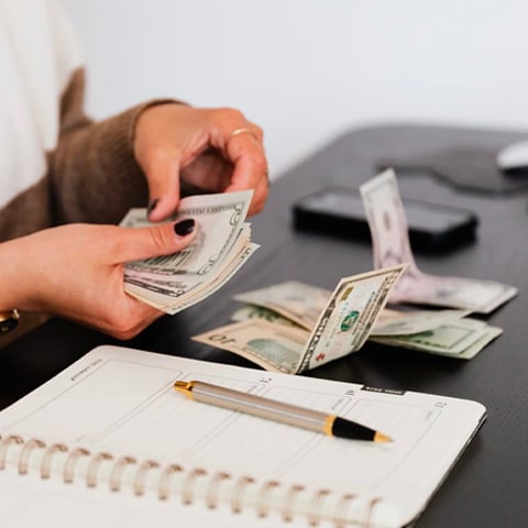 Payroll clerk counting money