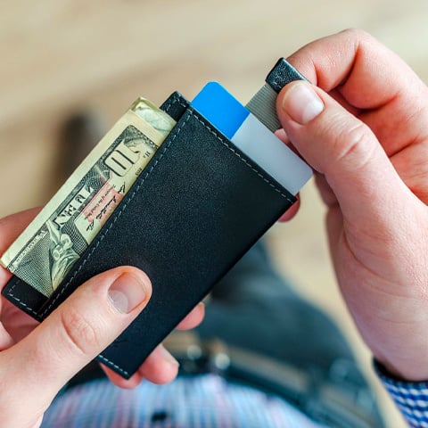 Person holding black card holder