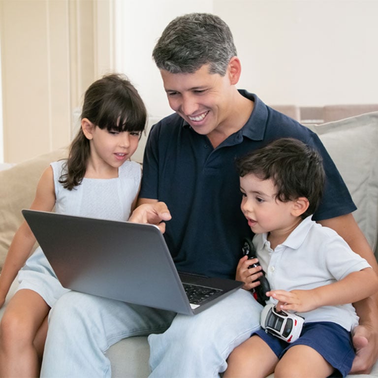 boat-loans-rates-at-allegiance-credit-union-are-affordable-man-with-two-children-looking-at-laptop-on-couch