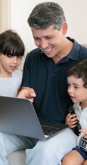 boat-loans-rates-at-allegiance-credit-union-are-affordable-man-with-two-children-looking-at-laptop