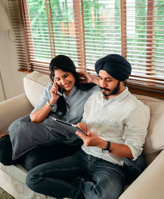 Happy ethnic couple using tablet