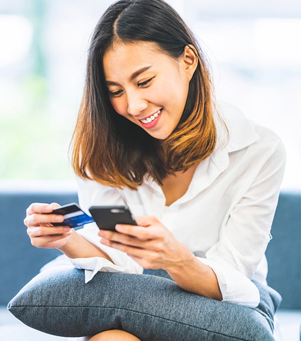 young asian woman using smartphone and credit card