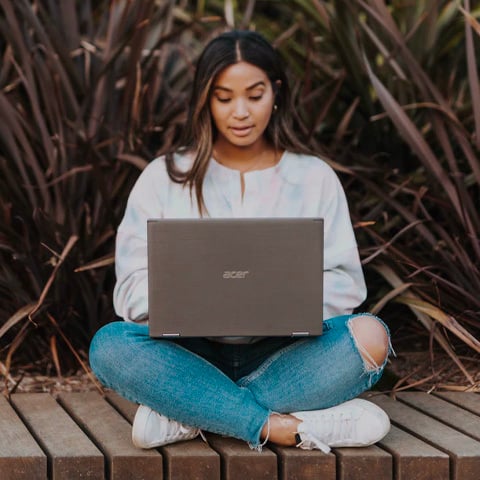 woman in white long sleeve shirt on laptop