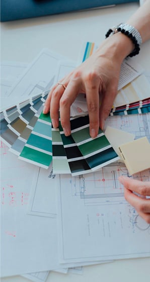 person holding green and white striped paper