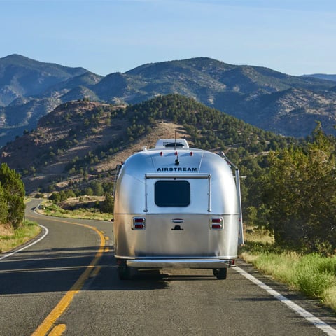 grey and brown vehicle driving down road