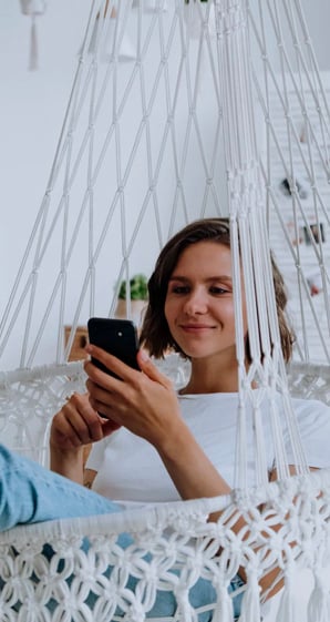 woman in white dress holding her phone